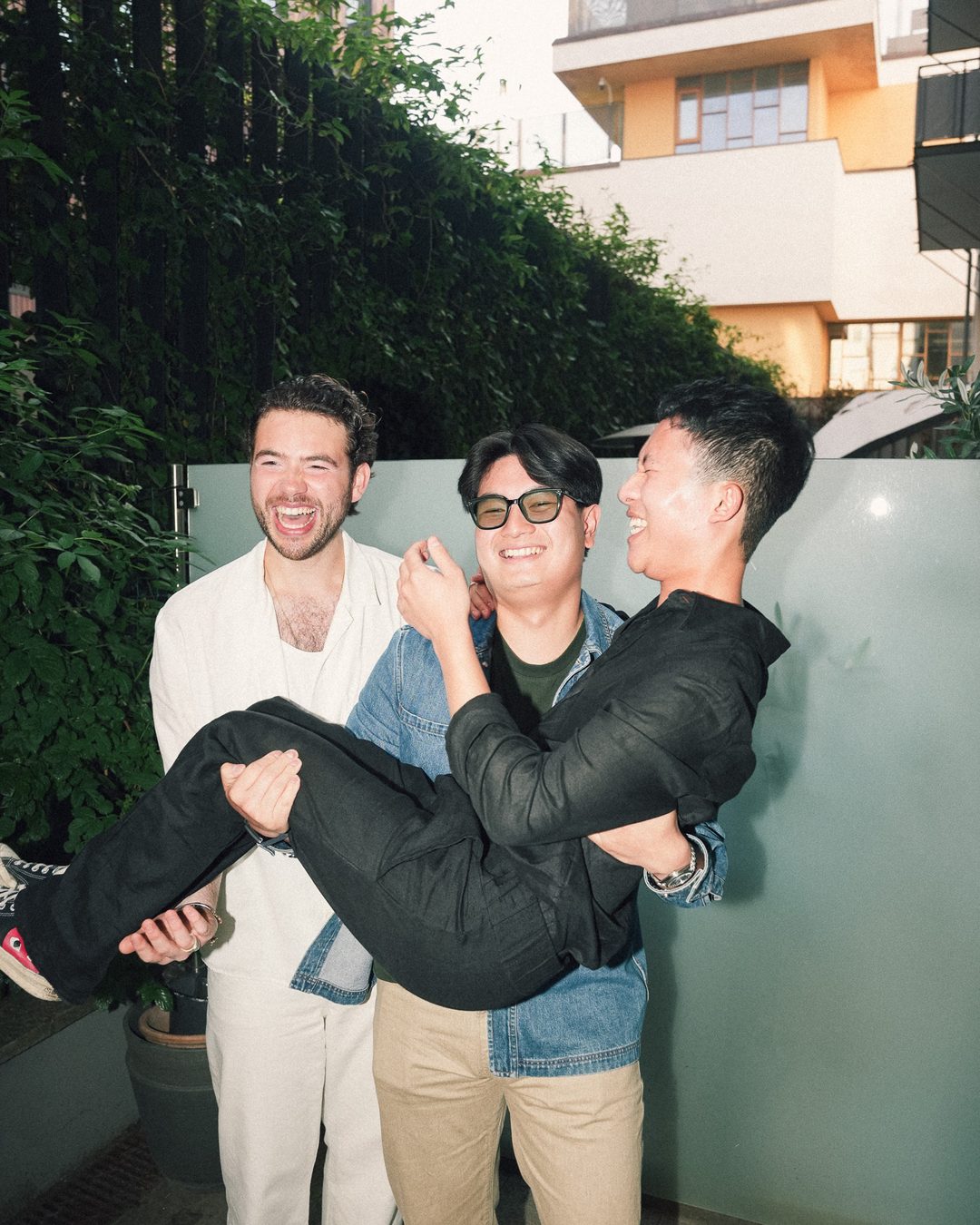 Friends carrying a laughing guest on the terrace, Seraya AW1 party — photo by vinny.mp4, Stockholm